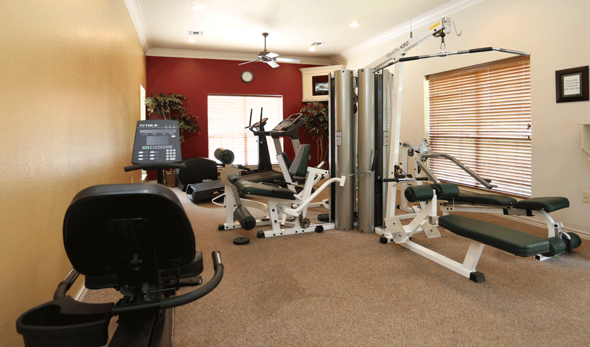 Fitness center with different types of workout equipment.