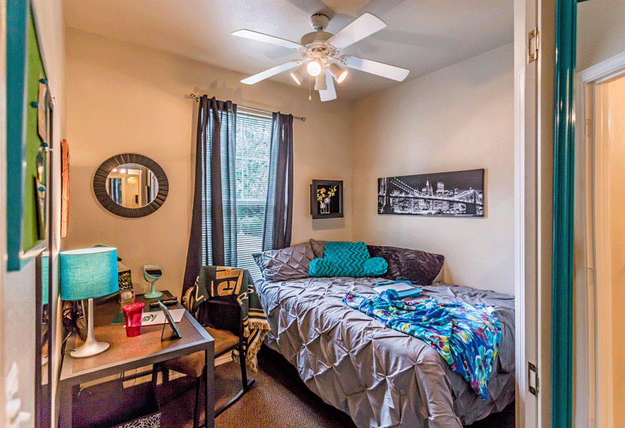 Furnished bedroom with ceiling fan