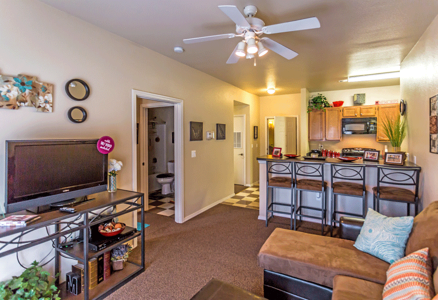 Furnished living area and breakfast bar with chairs