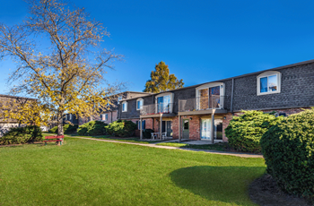 Building exterior with grassy area and landscaping