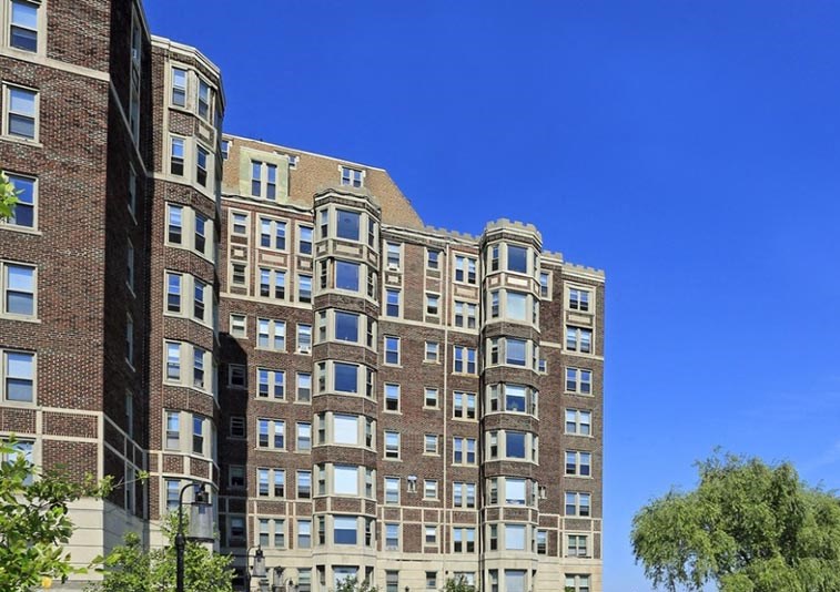 Alden Towers on the Detroit River. Alden Towers apartment building sitting alongside the Detroit River with sidewalk paths.