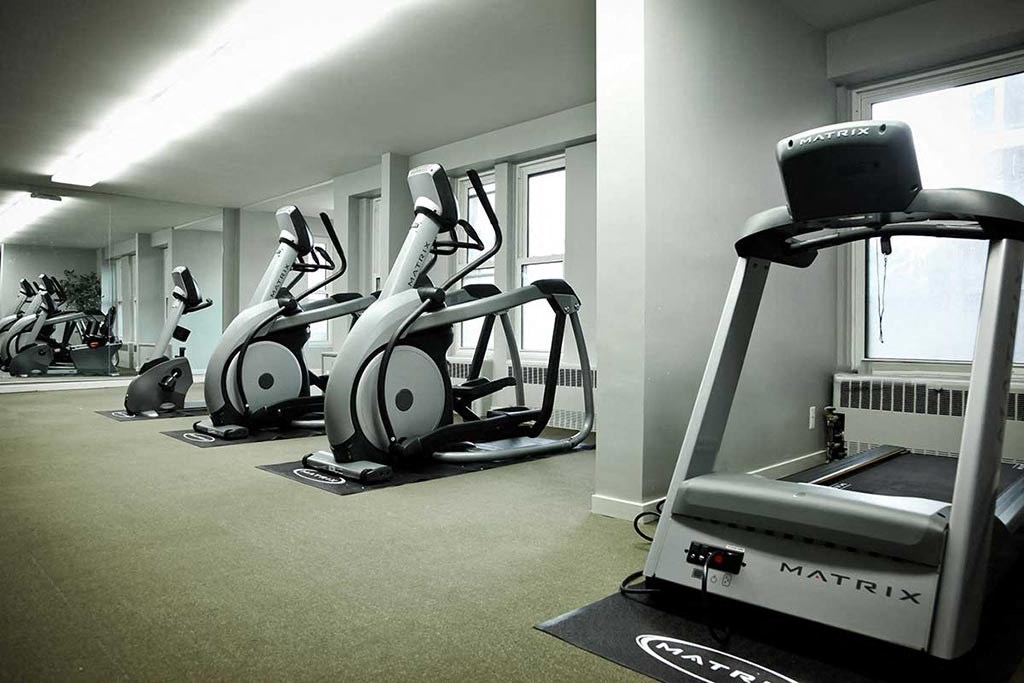 Fitness center with treadmill and exercise bikes.
