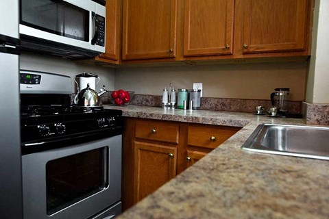 a kitchen with stainless steel appliances and granite counter tops