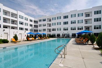 a swimming pool with a white building in the background at The George, Michigan, 48104