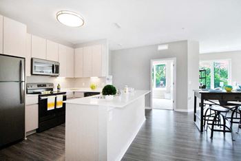 a kitchen with a large white island next to a doorway