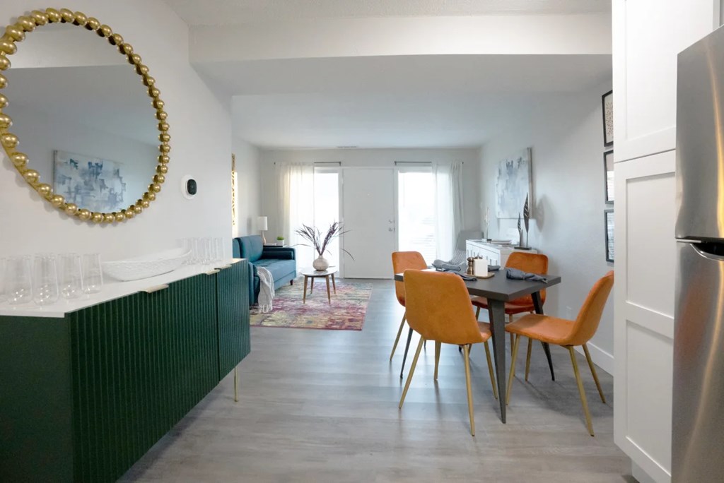 A dining room with a table and chairs.