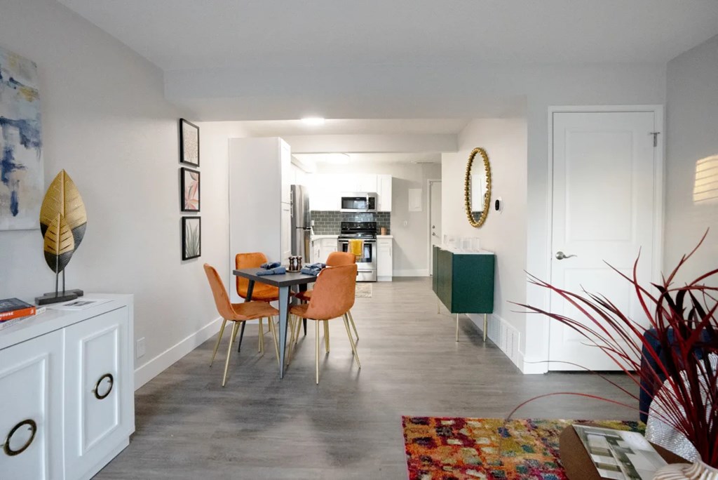 A dining room with a table and chairs.