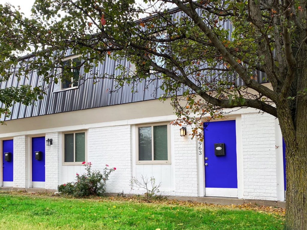 A white house with blue doors and windows.