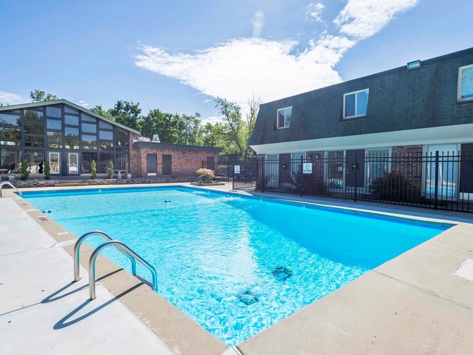 A large swimming pool in front of a building.