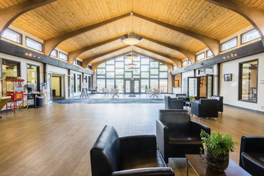 A large room with a high ceiling and wooden floors.