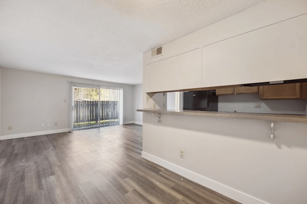 A room with wooden floors and white walls.