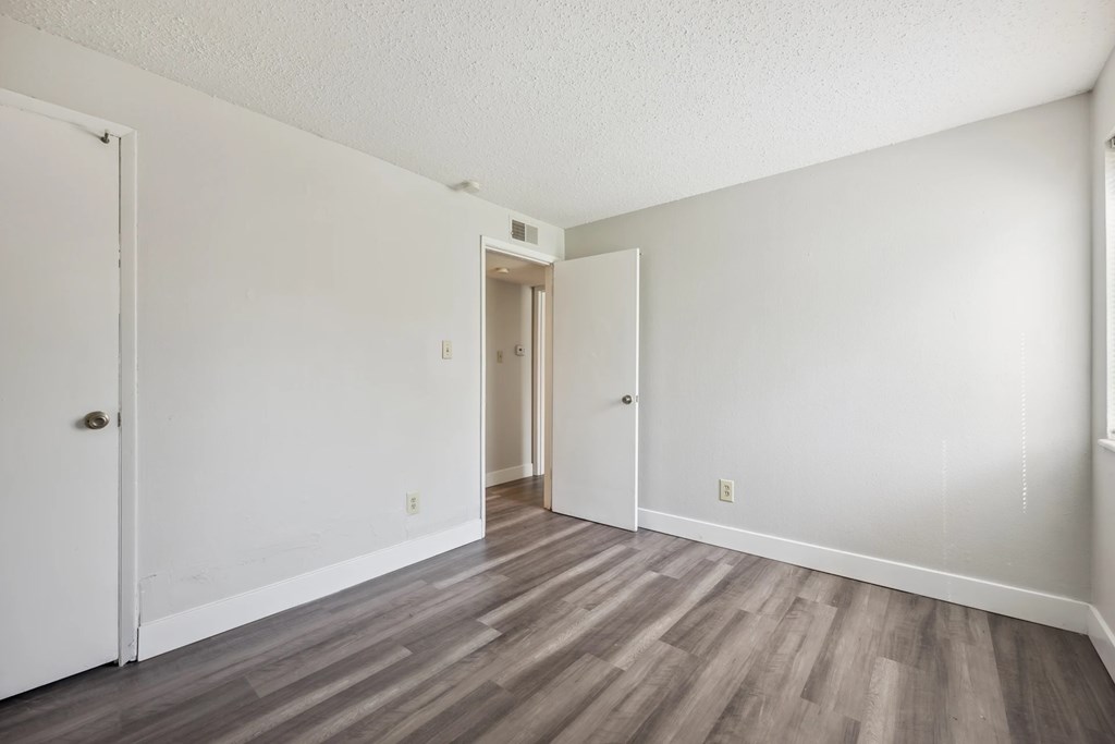 A room with a white door and a white wall.