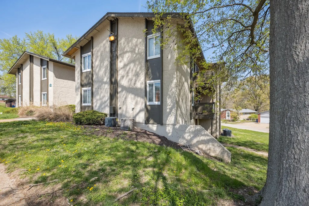 A modern two-story house with a large front yard.