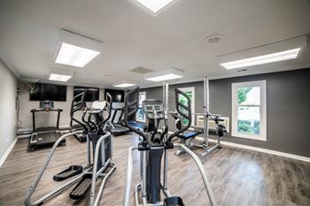 A spacious gym with treadmills, elliptical machines, and other exercise equipment.