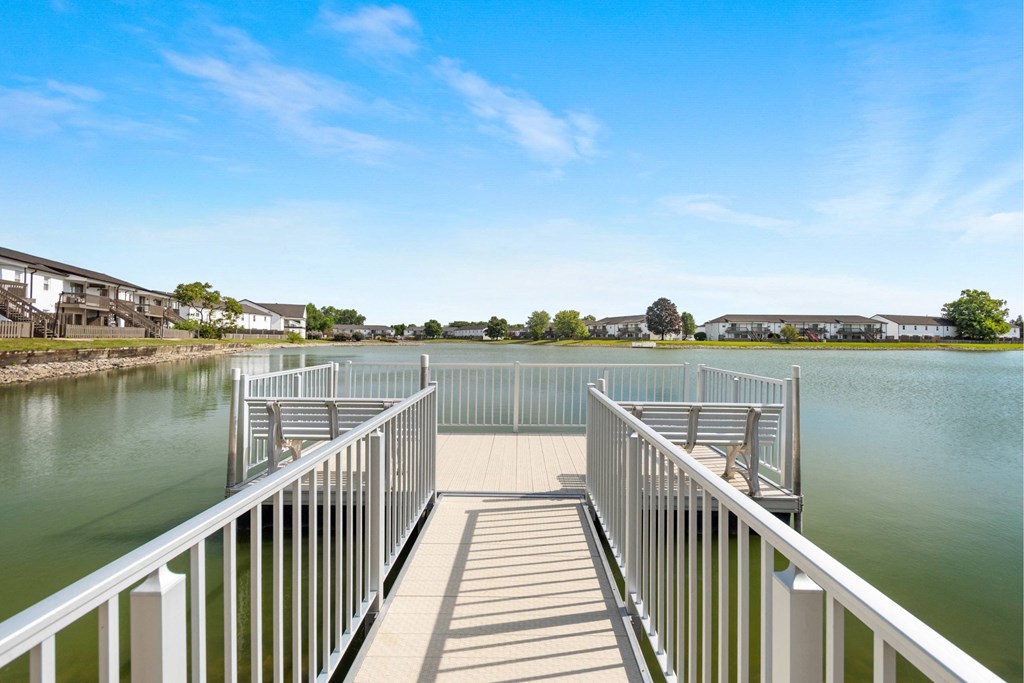 A bridge over a body of water with a clear blue sky above.