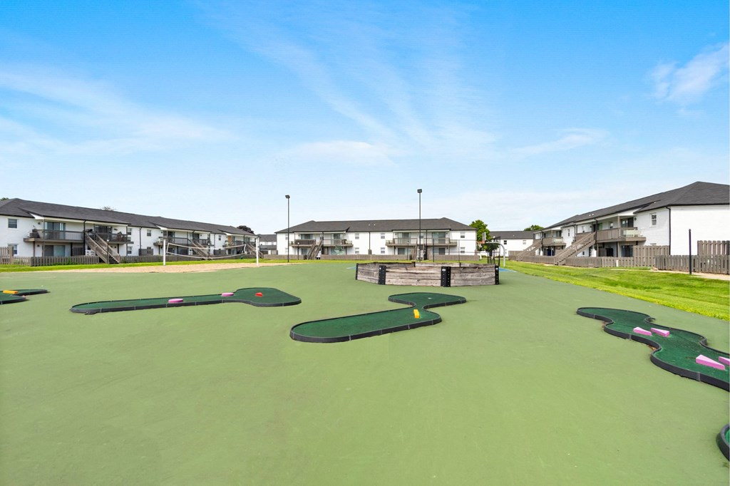 A miniature golf course with green and yellow flags.