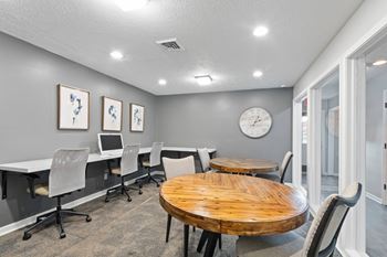 A conference room with a large table and chairs.