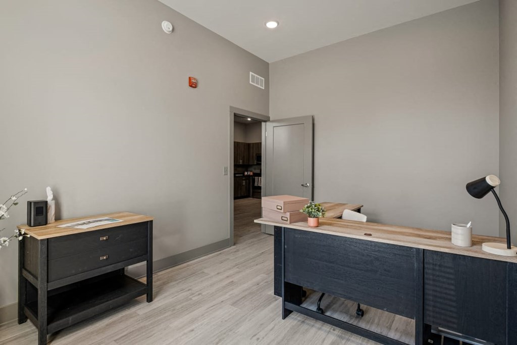 a office with a desk and a door to a hallway