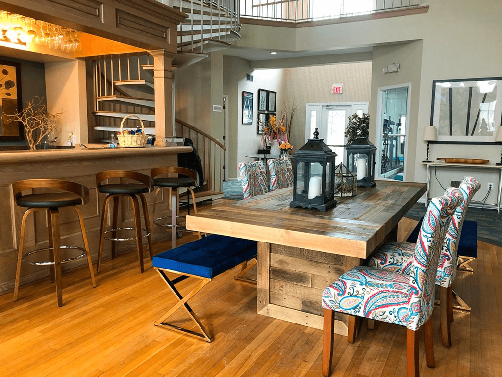 A dining area with a wooden table and chairs.