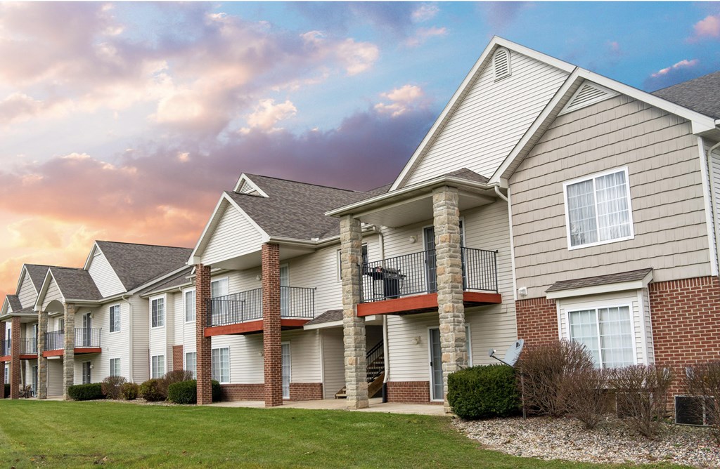 Apartment Building exterior. Bright and siding two story building with sunset.