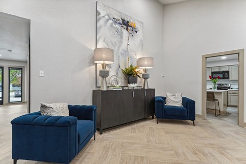 A living room with a blue sofa and a grey cabinet.