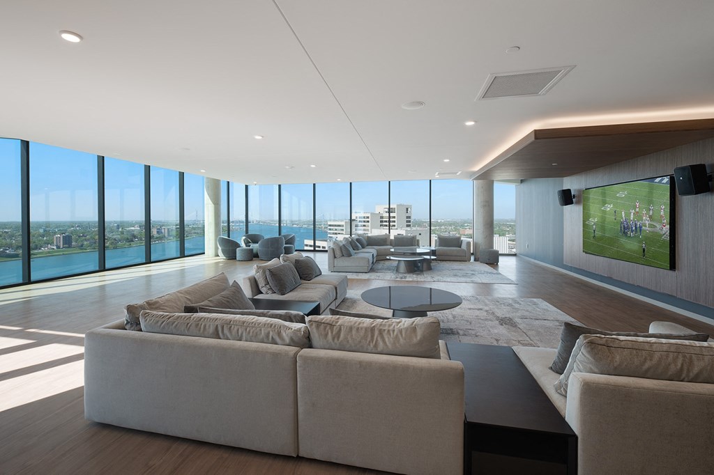 a living room with couches and a table and a television