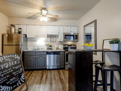 A kitchen with a chalkboard sign that says upgrades.