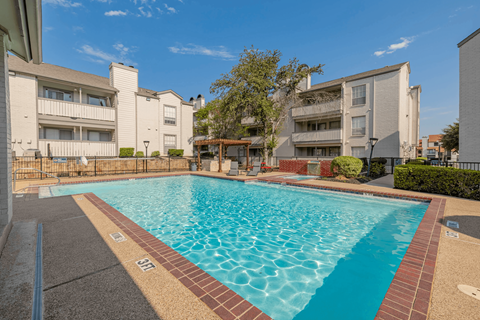 A swimming pool surrounded by apartment buildings.