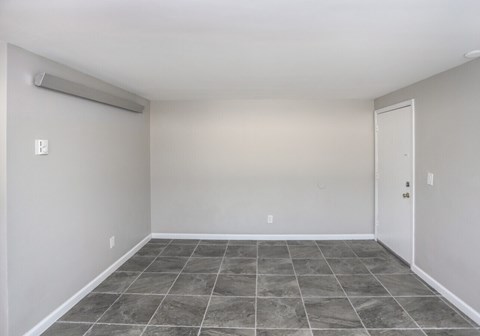 A room with a tiled floor and a sliding door.