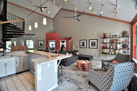 a large living room with a kitchen and a table