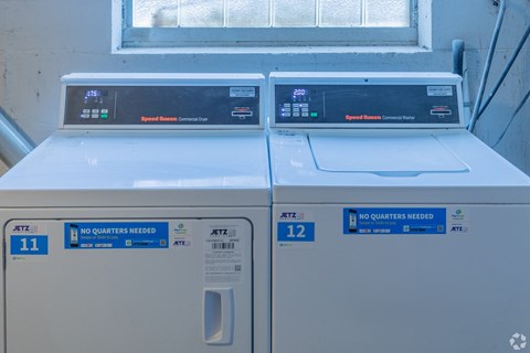 Two identical washing machines are side by side.