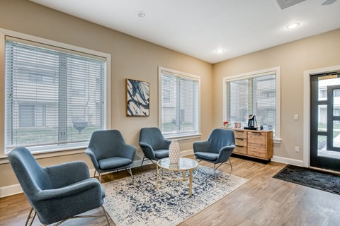 A living room with grey chairs and a white table.