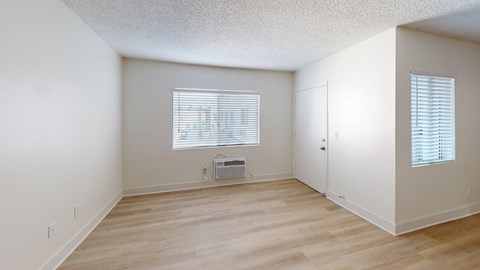 A room with a window and a door.