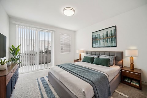 A bedroom with a large bed and a television.