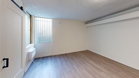 A room with a window and a door.