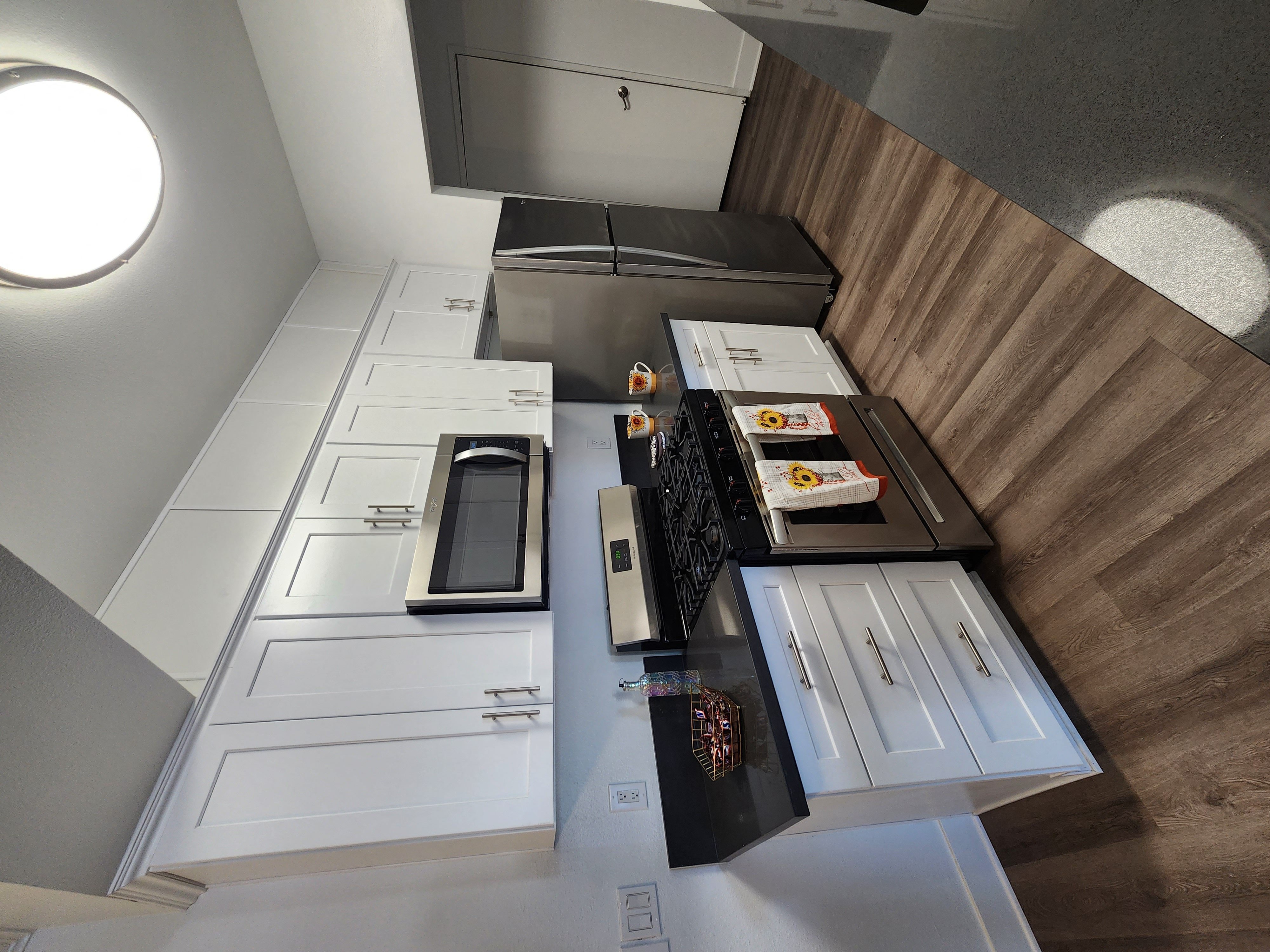 Upgraded kitchen with shaker doors, quartz countertops and wood-like flooring