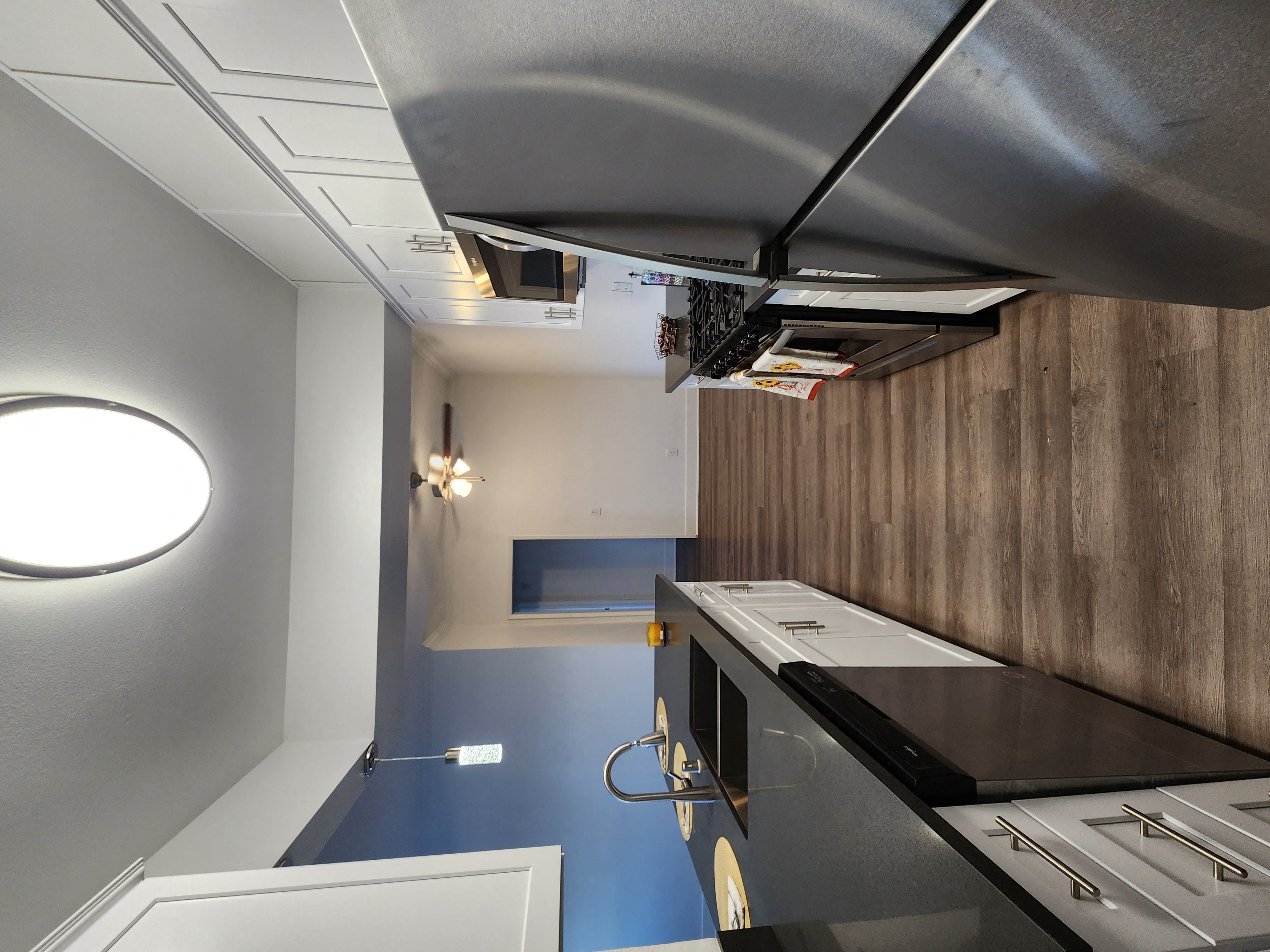 Upgraded kitchen with wood floors and stainless steel appliances