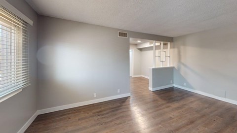 A room with wooden flooring and a white ceiling.