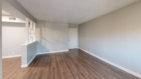 A room with wooden floors and white walls.