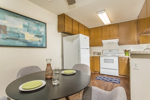 a kitchen and dining room with a table and chairs