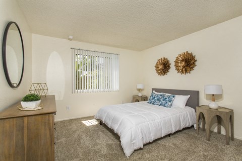bedroom with queen bed and window