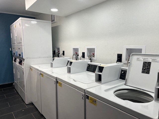 A row of washing machines in a laundromat.