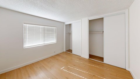 A room with wooden floors and white walls.