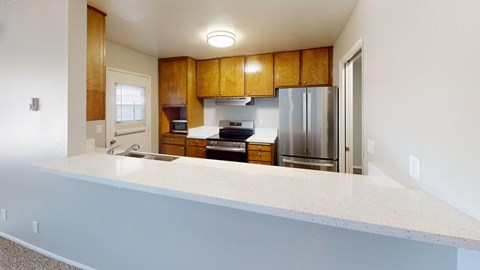 A kitchen with wooden cabinets and stainless steel appliances.