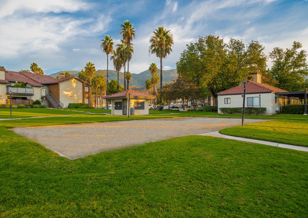 a street with houses and palm trees in the background