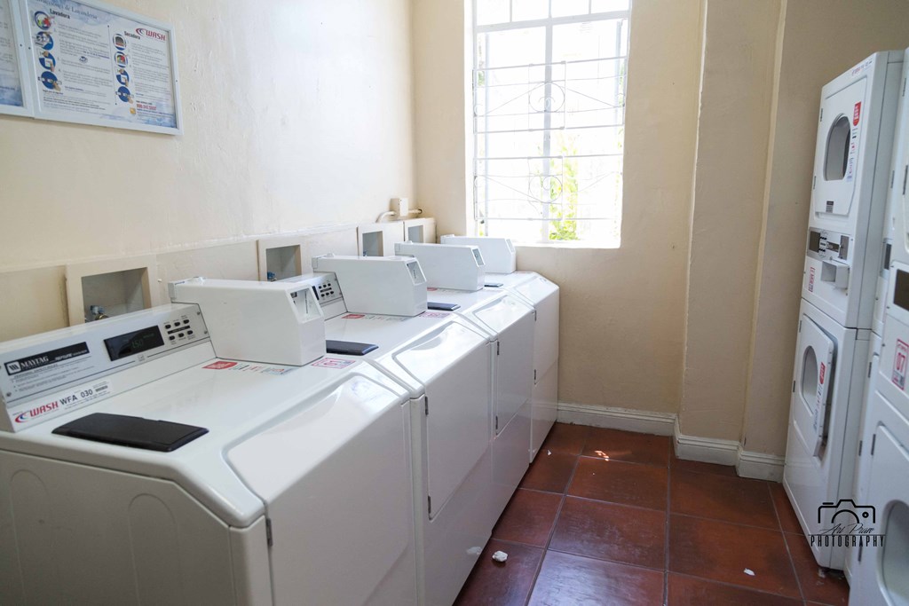 view of the dryers and window of laundry room