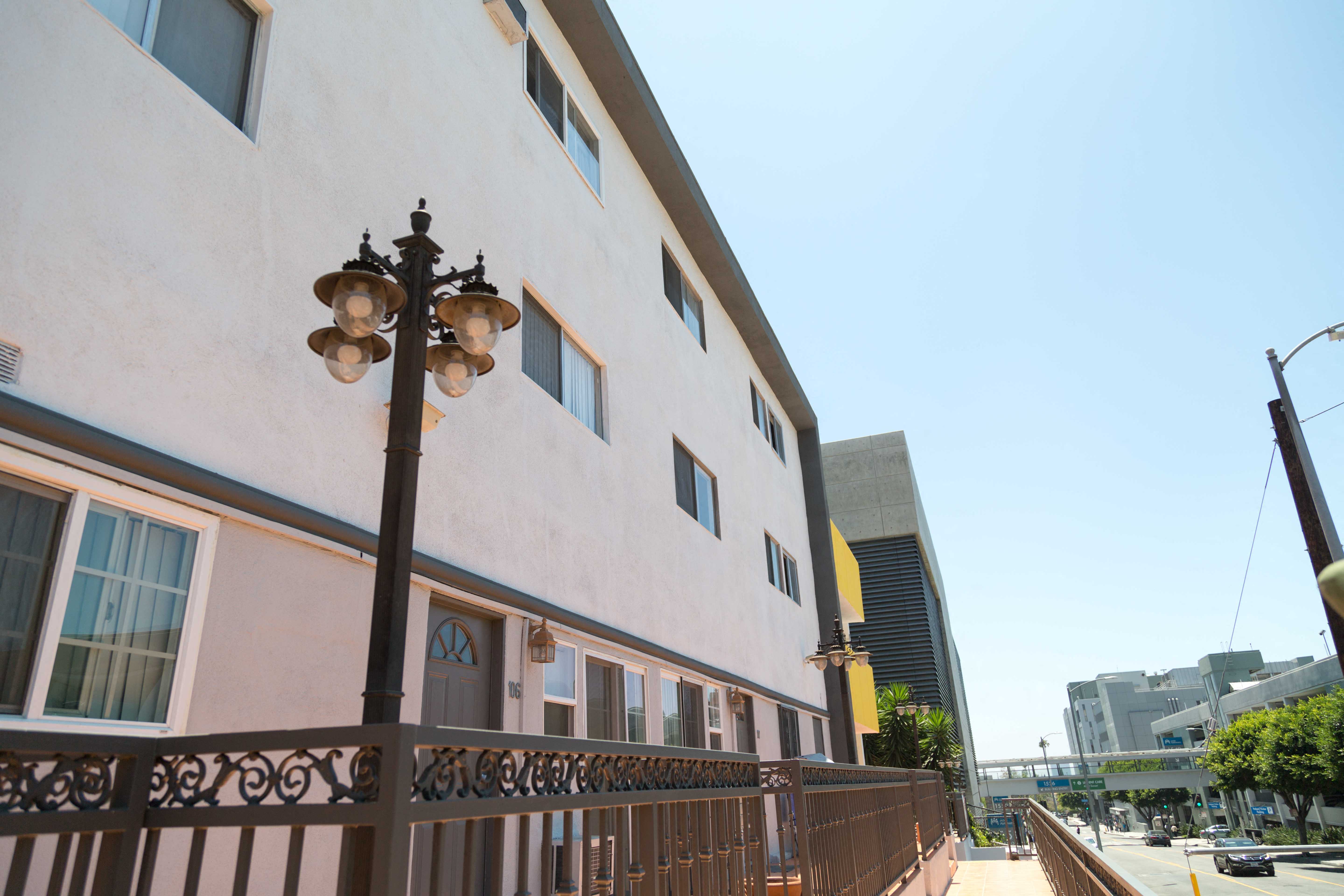 front of building with outdoor lighting and view of the street