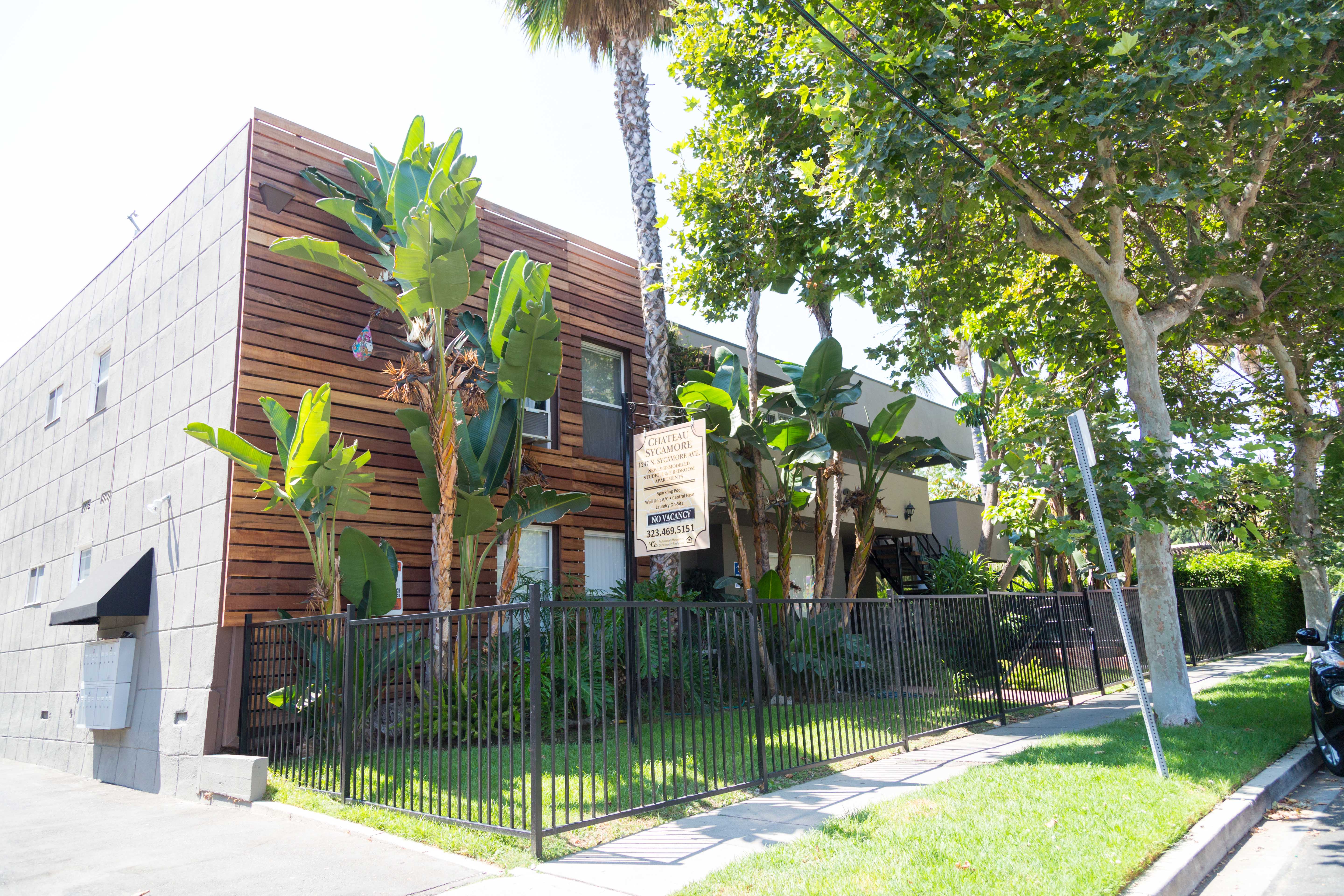 Front of building with sidewalk and leasing signs