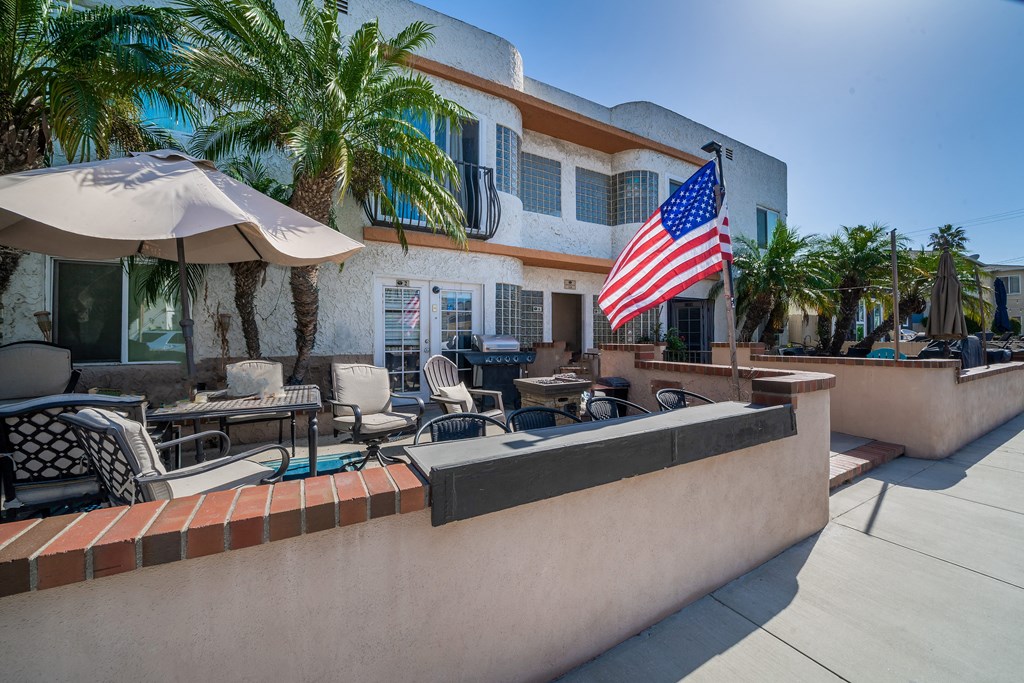 Belmont Building side view the American flag flies on a wall in front of a building