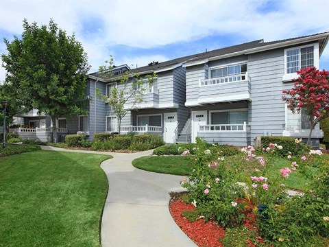 View of building entrance with landscaping and walkway